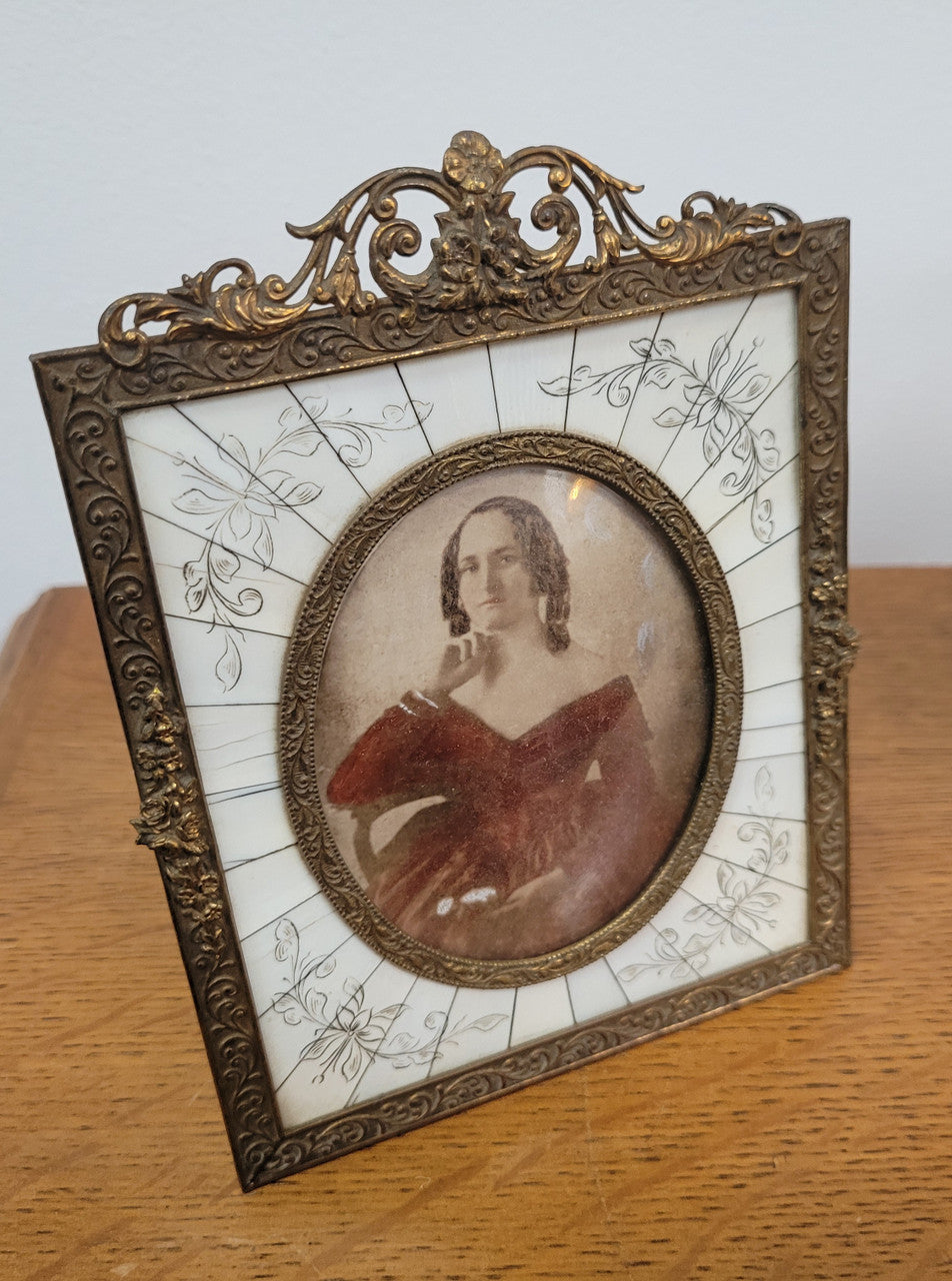 Hand coloured early photo of women in a stunning frame with paino key surround and detailed gilded metal frame.