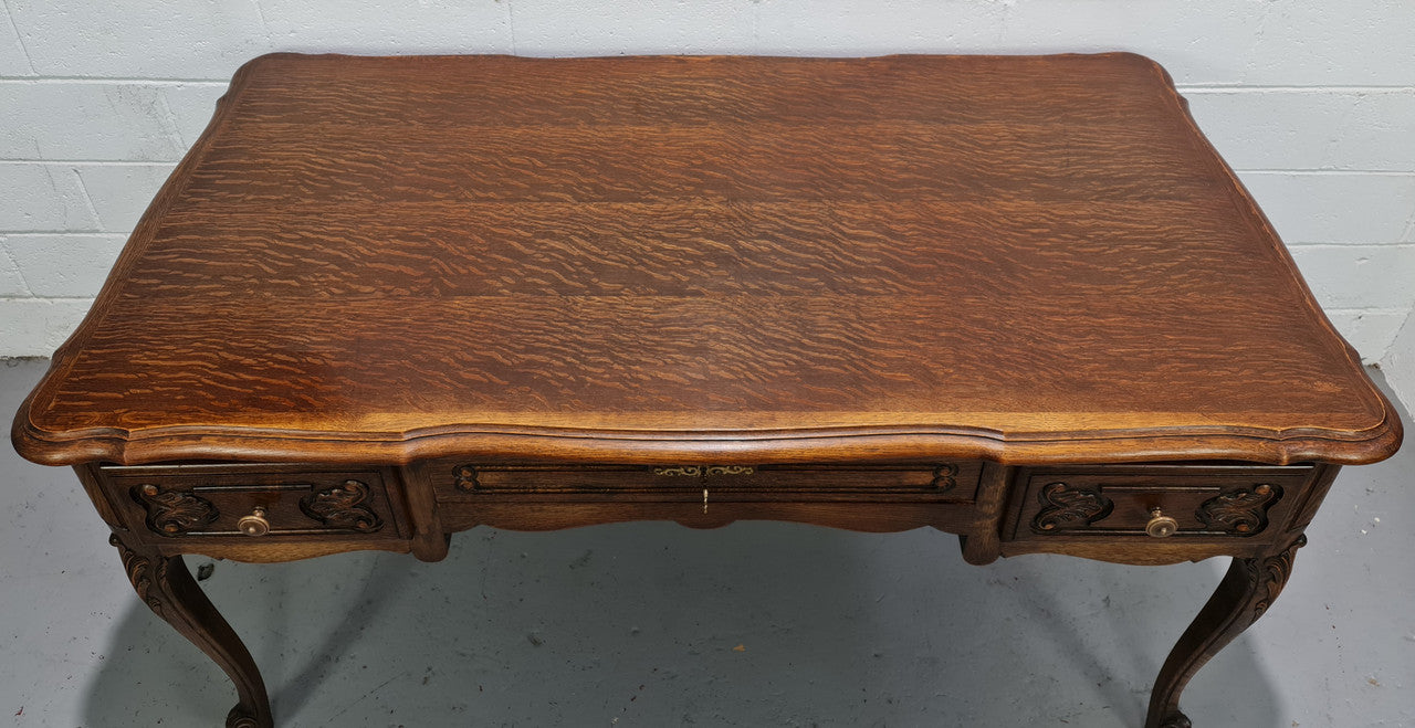 Attractive large Louis XV style Oak faux partners desk. Nicely carved details with three large functioning drawers, and three faux drawers at the back. In good original detailed condition.
