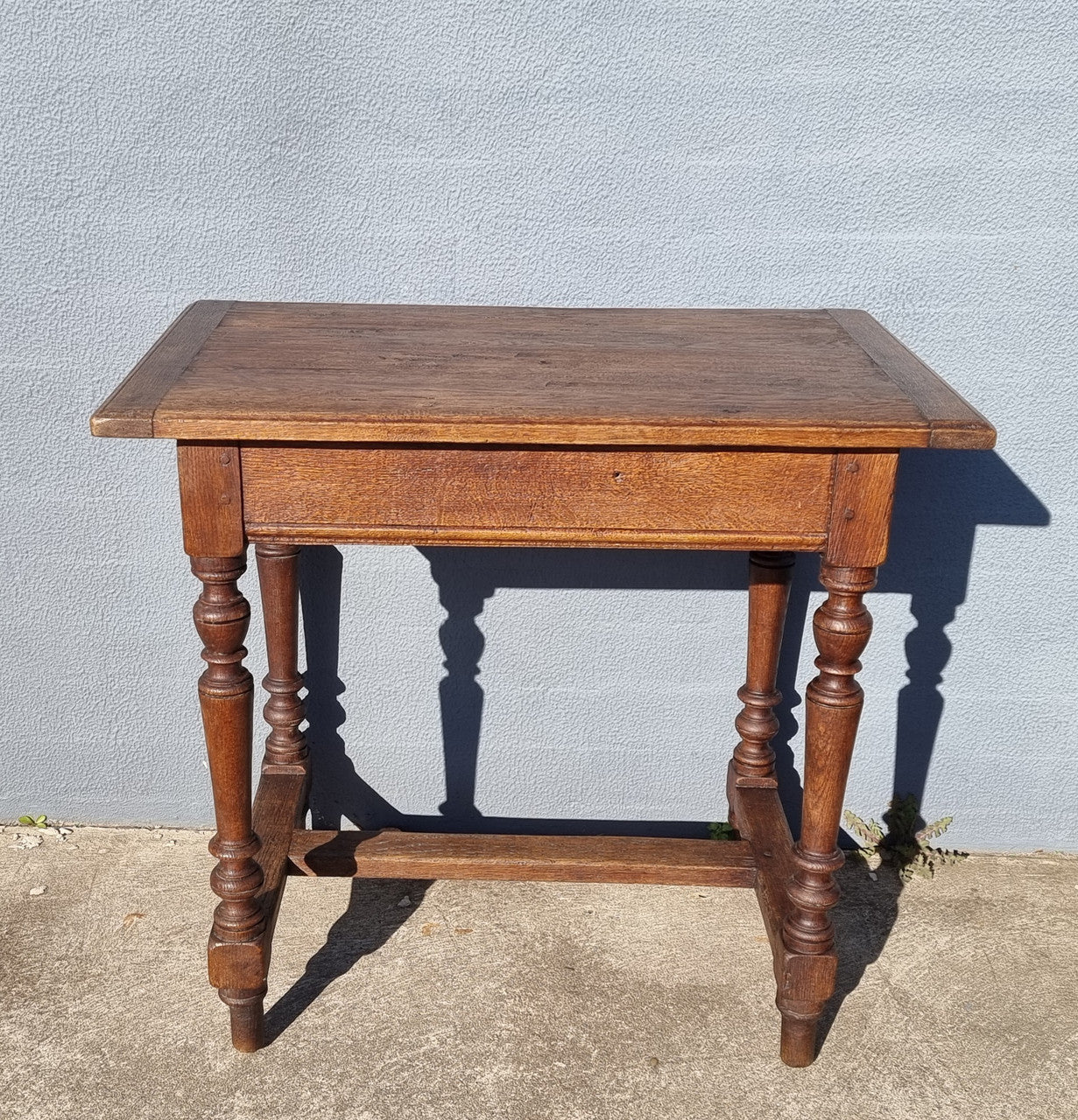 Rustic French Oak side table/desk with turned legs. In good original condition.