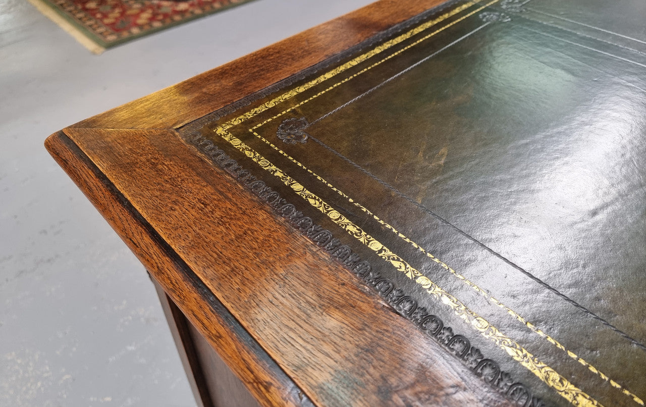 Fabulous Louis XV style French Oak beautifully carved full partners desk with an amazing tooled leather top. Both sides have a functioning drawer in the middle and two cupboards either side. On both sides one cupboard door opens up to four smaller internal drawers. Plenty of storage space and a large top surface to work on. It is in good original detailed condition.
