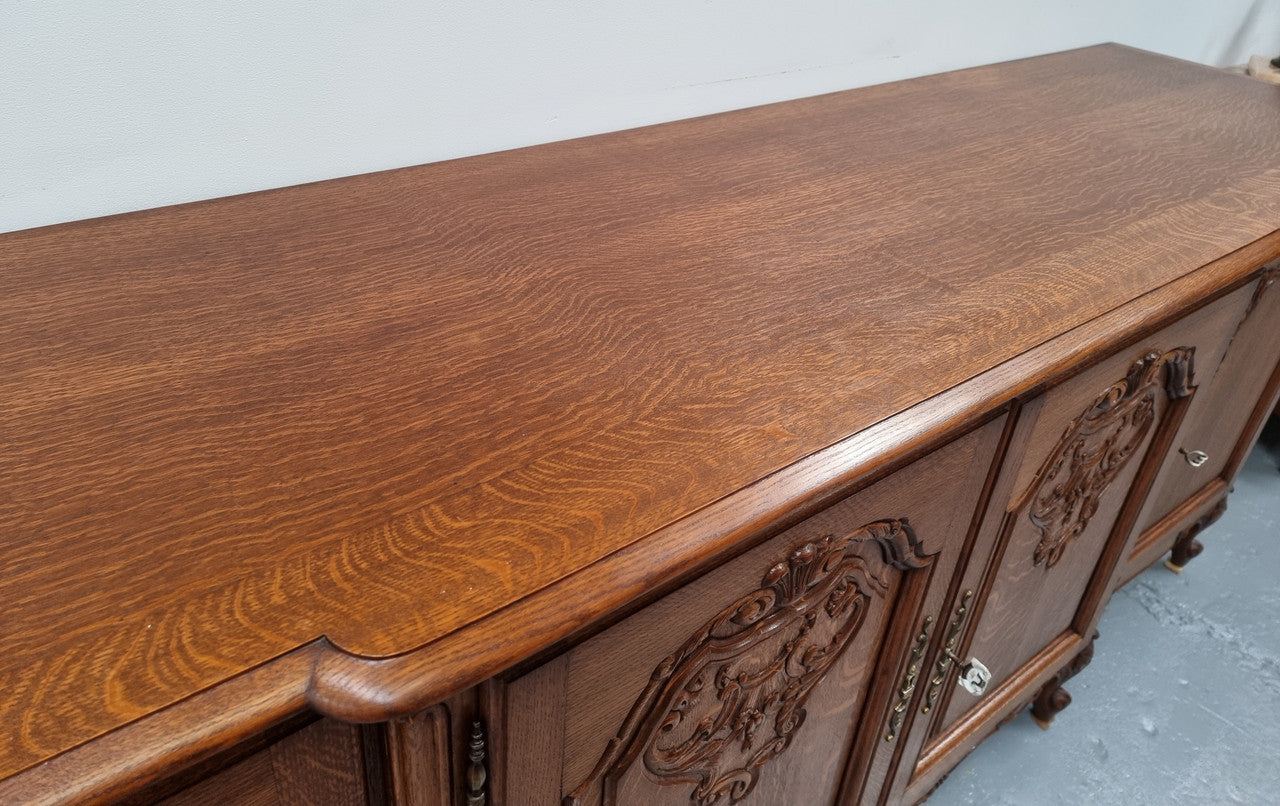 French oak large, beautifully carved four door sideboard with lockable doors and plenty of room for storage in good original condition.