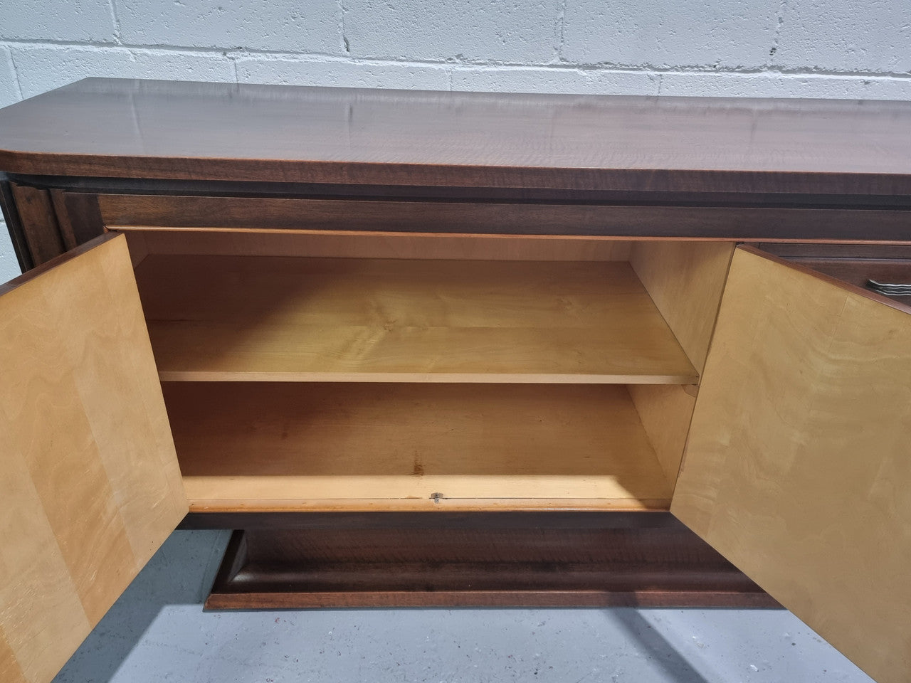 Amazing French Walnut Art deco four door buffet. The doors either side open to a fixed shelf and plenty of added storage with four drawers. In good original detailed condition.