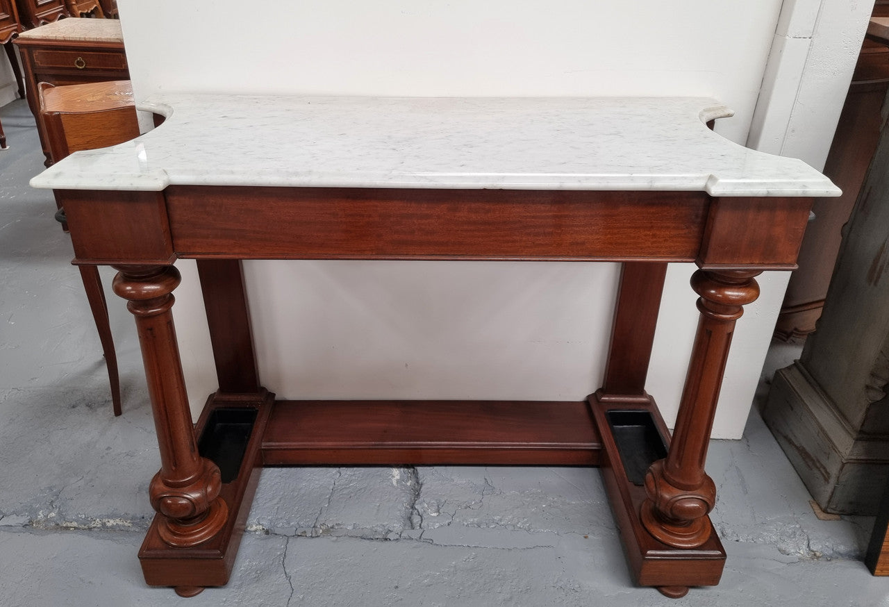 Classic Victorian mahogany console table with white marble top, one drawer and accommodation for sticks/umbrellas. In good original detailed condition.