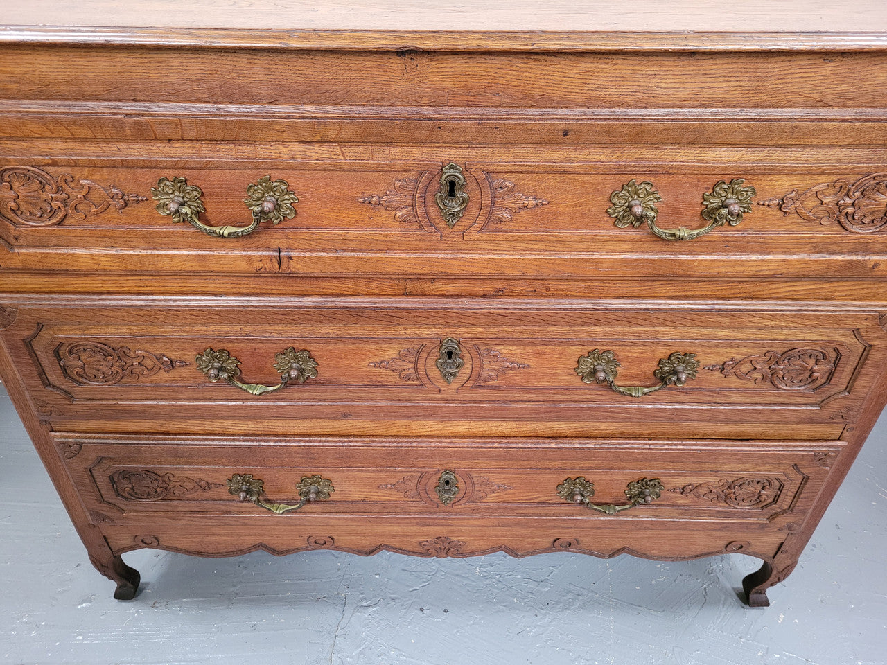 French Louis 15th style large three drawer chest featuring carved drawers. It has been sourced from France and is in good original detailed condition.