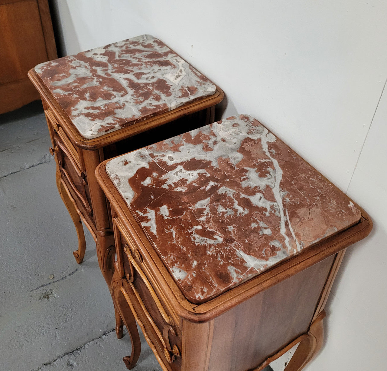 Pair French Walnut Louis XV style Bedside Cabinets with inset rouge carrera marble tops and parquetry inlay. Consisting of one drawer and one cupboard on very elegant legs. Circa: 1900's.