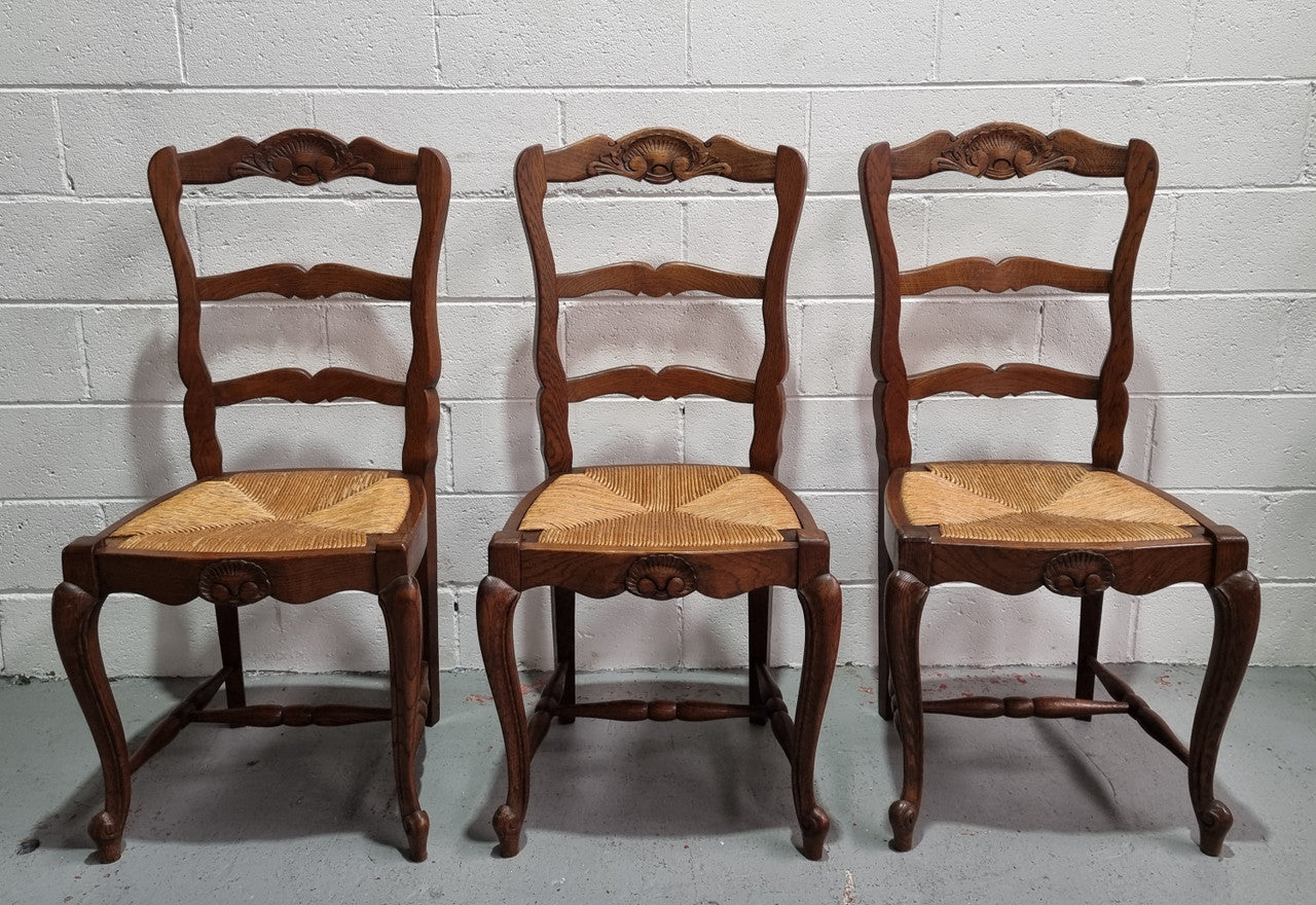 Lovely set of six French oak rush seated provincial dining chairs. They have been sourced from France and are in good detailed condition.