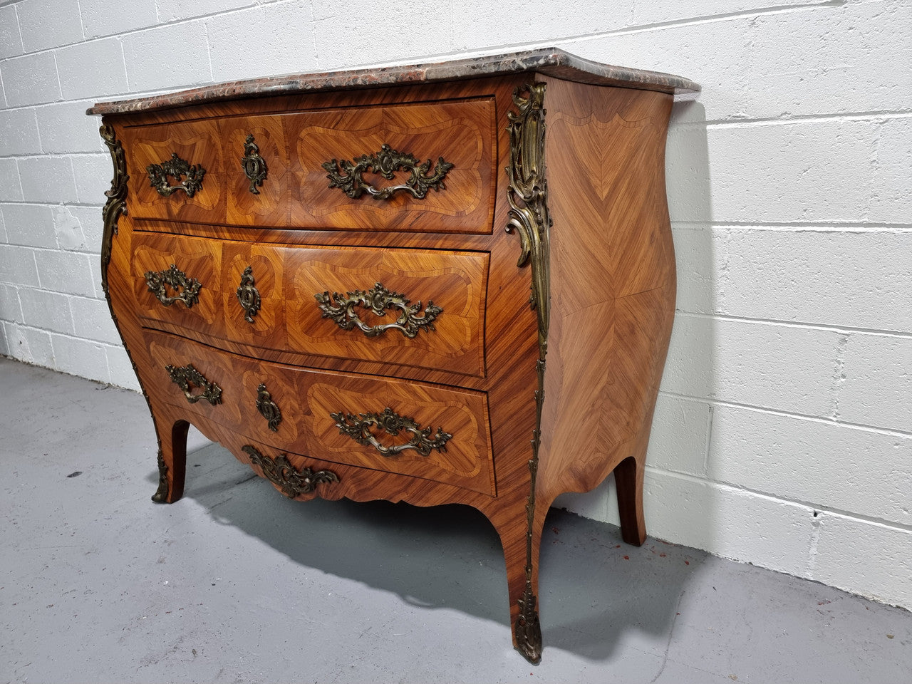 Attractive French marble top Louis XV style three drawer commode with decorative ormolu mounts. In good original detailed condition.