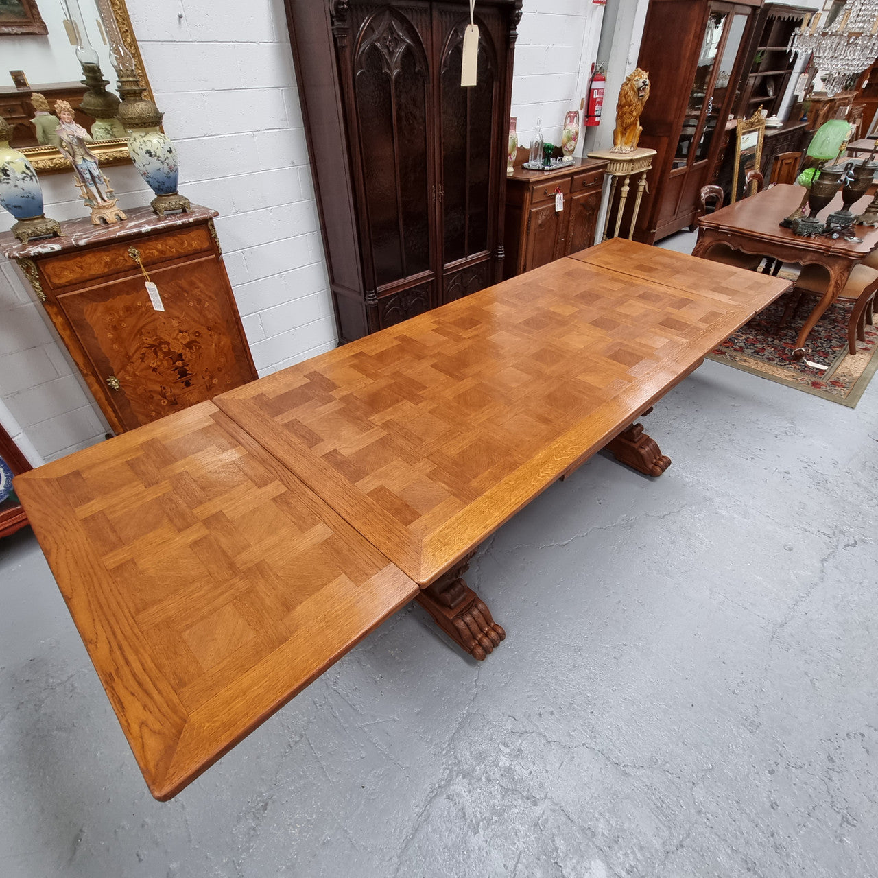 Amazing French Oak Renaissance style parquetry top extension table. Beautiful parquetry top and amazing detailed carvings on the legs. It extends to 306 cm long when fully extended. Sourced from France and in good original detailed condition.
