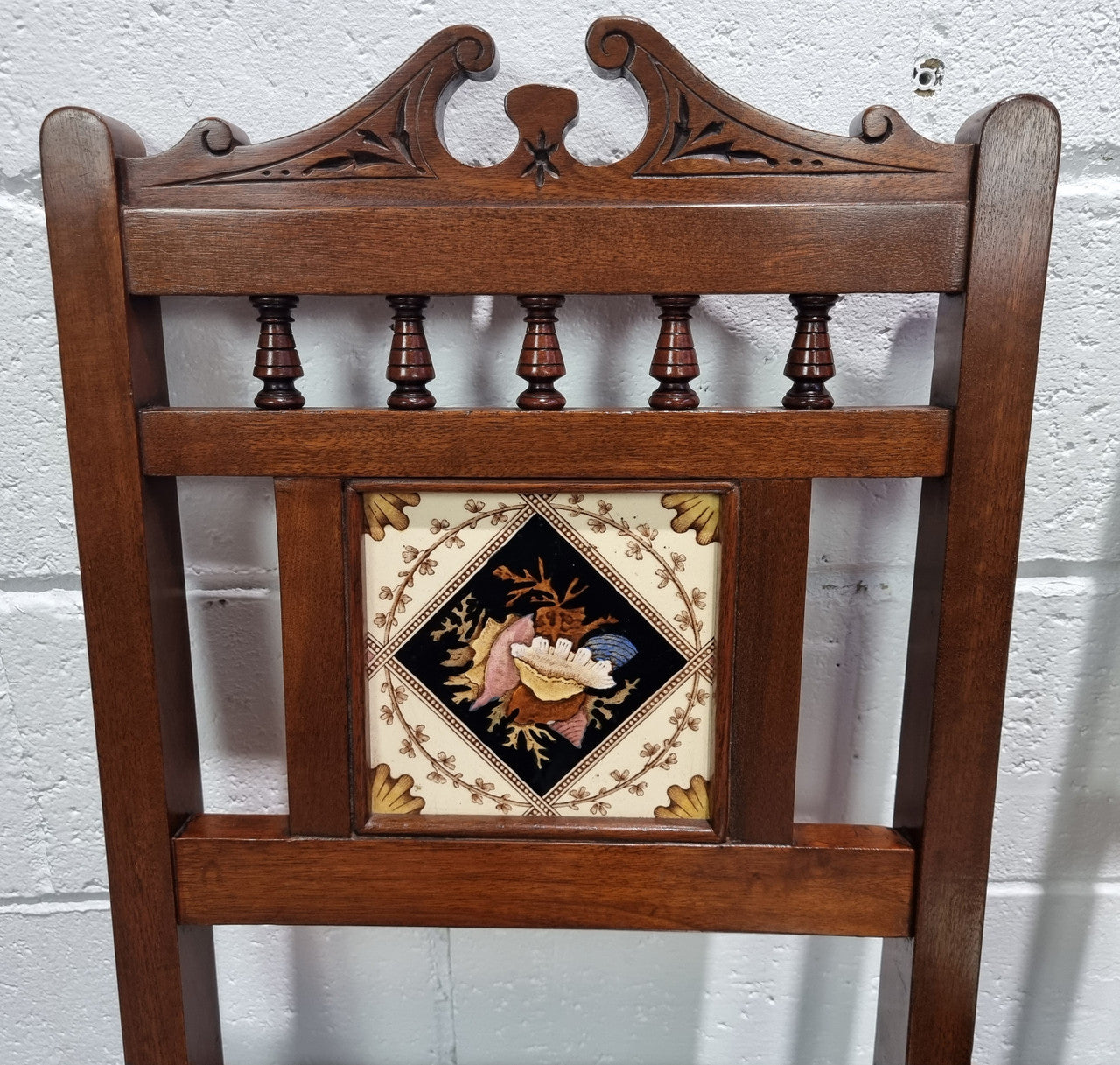 Pair of Edwardian Mahogany hall chairs with original tile in back. They are in very good original detailed condition.