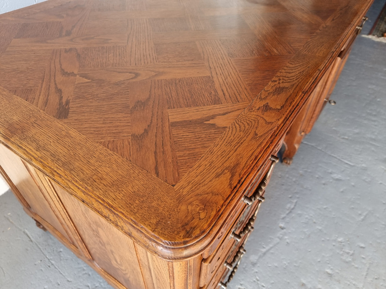 Beautifully carved french oak, faux partners desk with a lovely parquetry top and 6 drawers and 1 cupboard . In good original condition.