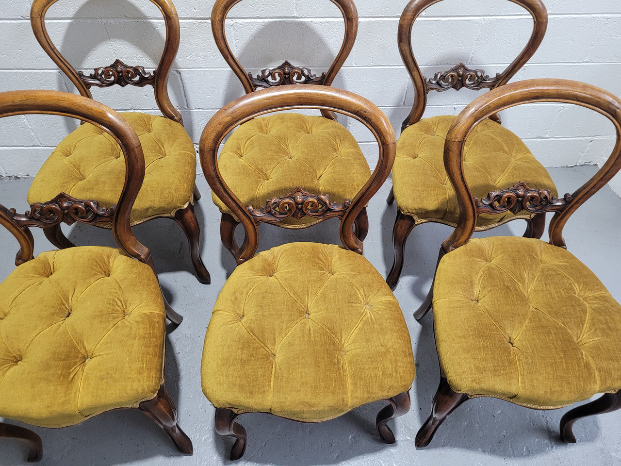 Set of six upholstered Victorian balloon back chairs. In good original detailed condition.