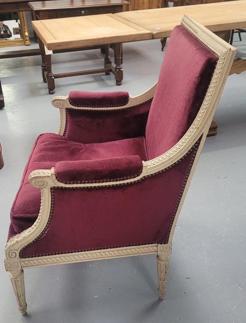Louis 16th Style high back upholstered chair with maroon velvet fabric, decorative carvings and original paint. It has been sourced from France and in good original condition.