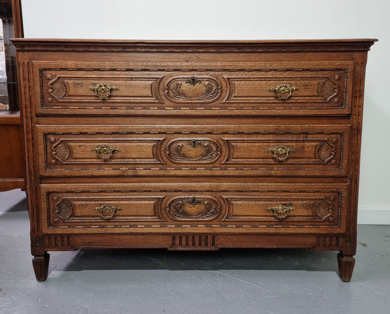 Early 19th Century French Oak chest of three drawers. It has beautiful handles and carvings. It is in good original detailed condition.
