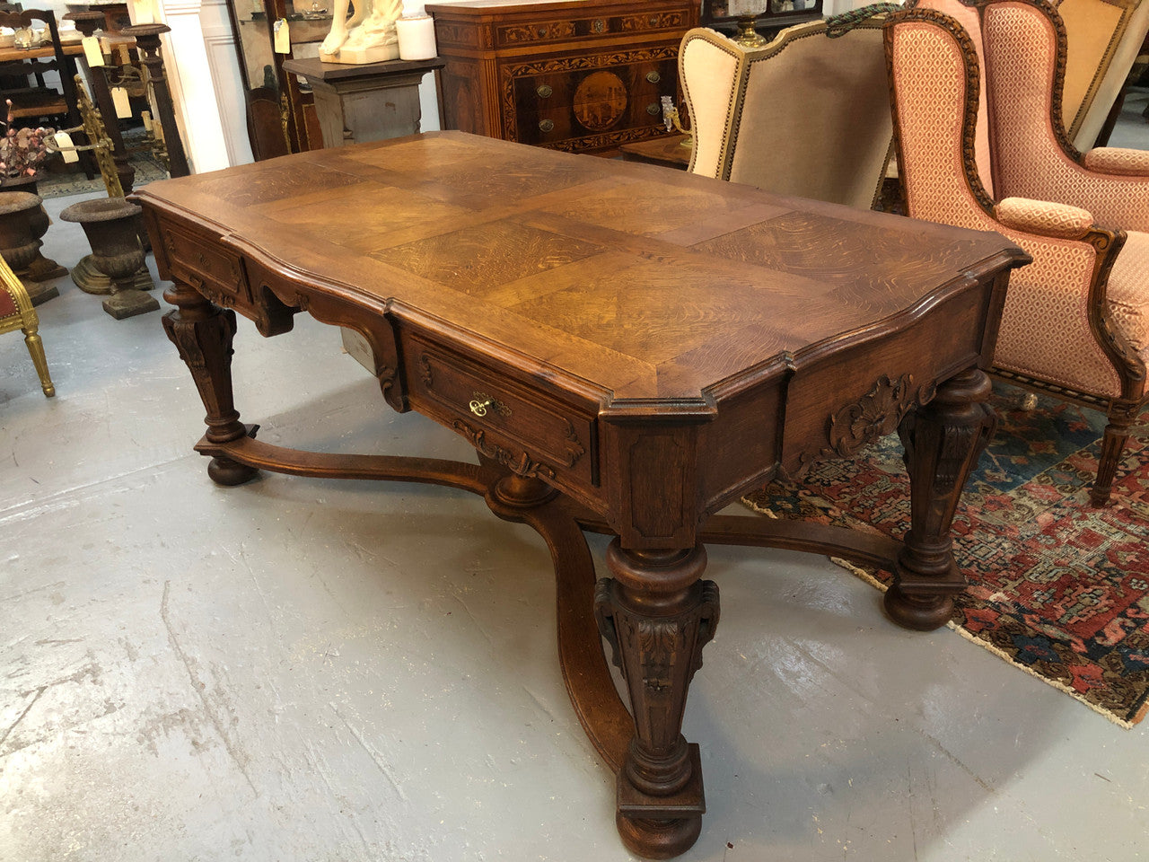Beautifully carved 19th century French oak Bureau Plat. With a lovely parquetry top and two drawers and decorative carved legs this piece is definitely one to look at . In good original detailed condition.