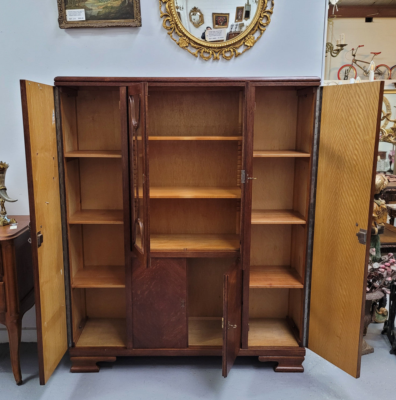 Stylish French Art Deco Oak bookcase with heaps of storage space and shelves. Middle section has two glass display doors. In good original detailed condition.