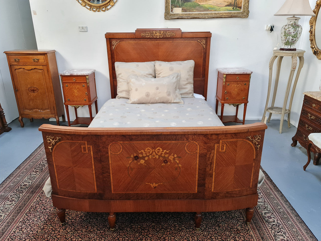 A high quality French Louis XV style bow fronted Queen size bed with marquetry inlay and ormolu mounts. In good original detailed condition. Circa: 1920