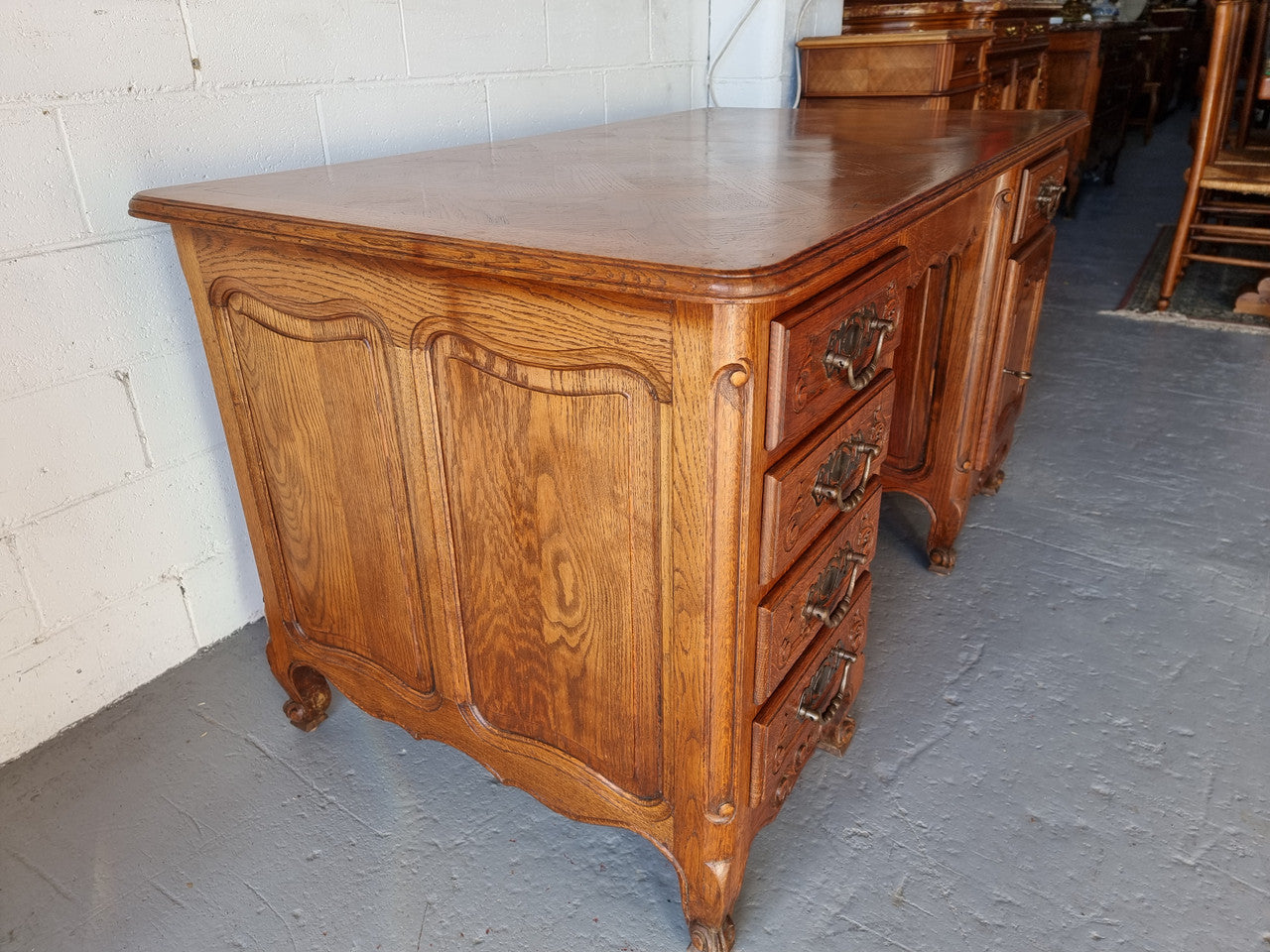 Beautifully carved french oak, faux partners desk with a lovely parquetry top and 6 drawers and 1 cupboard . In good original condition.