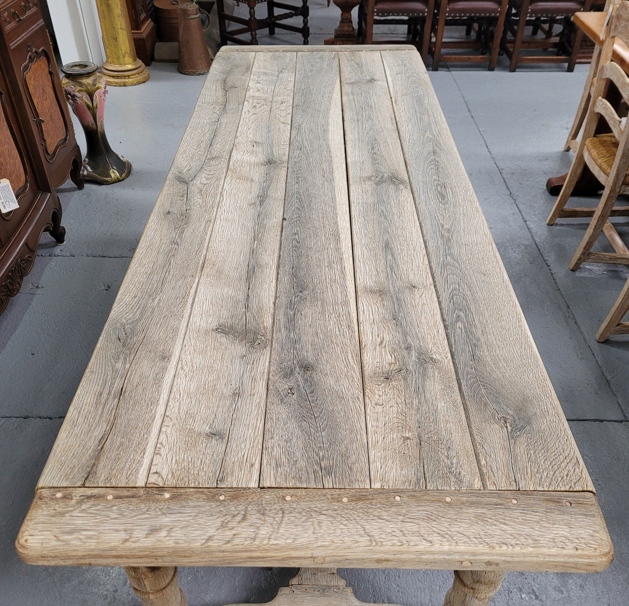 French stripped Oak pedestal stretcher base Farmhouse table with two drawers on either side of table. Features raw wood that could be used as is for a distressed look, or finished and waxed for a more refined look.
