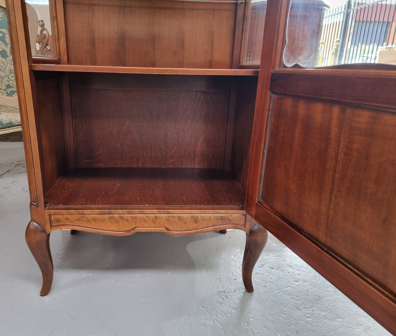 Petite French Louis XV style Walnut display cabinet with two glass shelves that can be adjusted and added storage at the bottom . In very good original detailed condition.