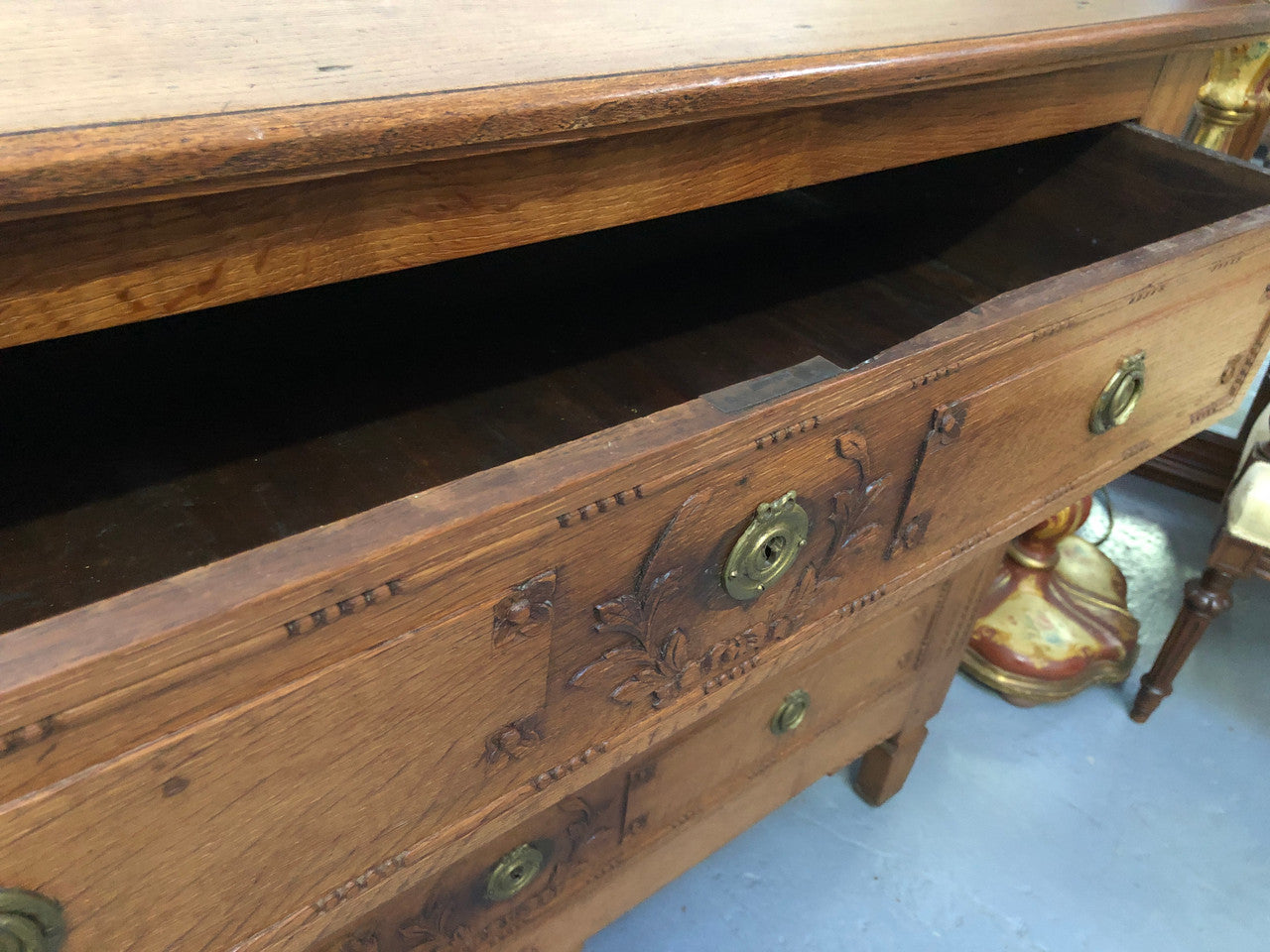 Lovely carved early 19th Century French Oak commode. There are three drawers with decorative drawer pulls and is in good original detailed condition.