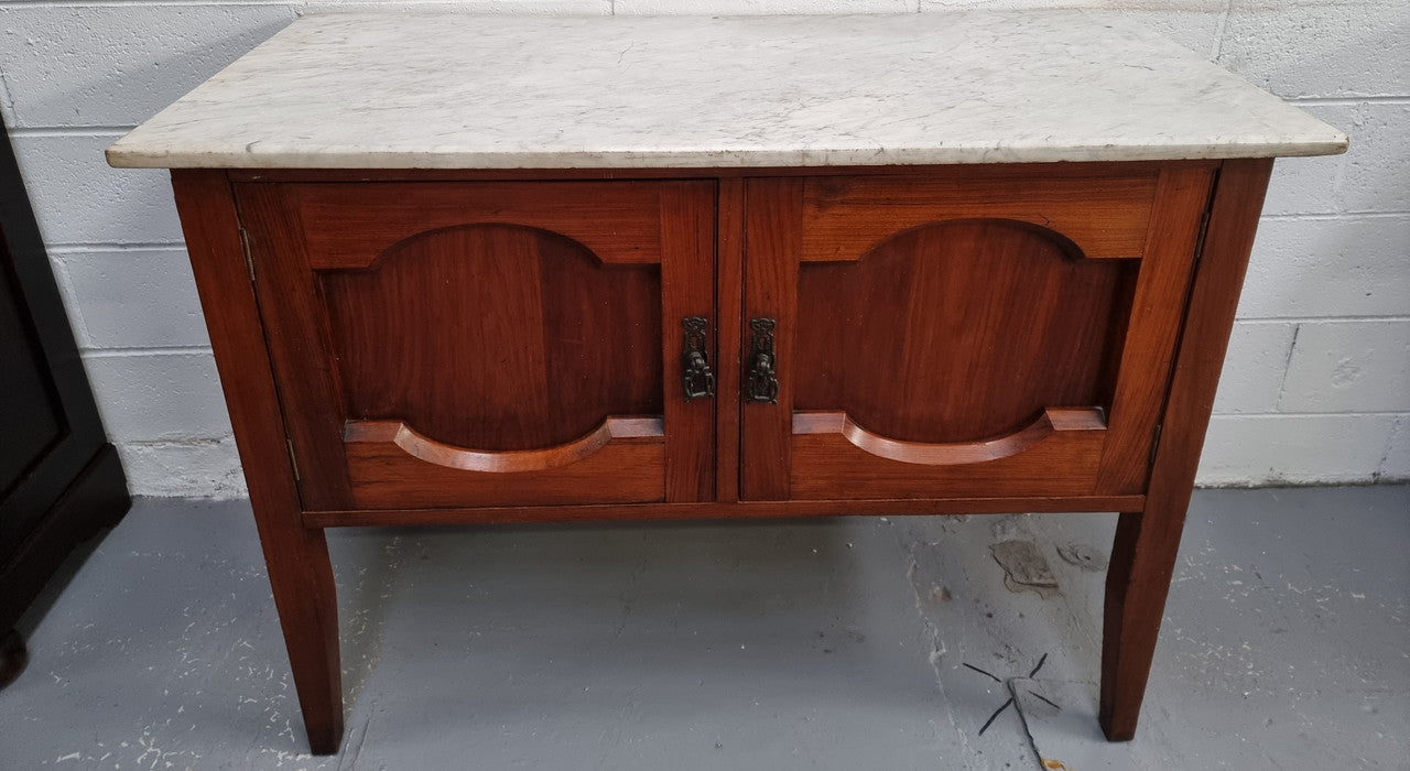 Blackwood two door white marble top cabinet. This would be ideal to be used as an entertainment unit, a TV stand or TV cabinet. In good original condition.
