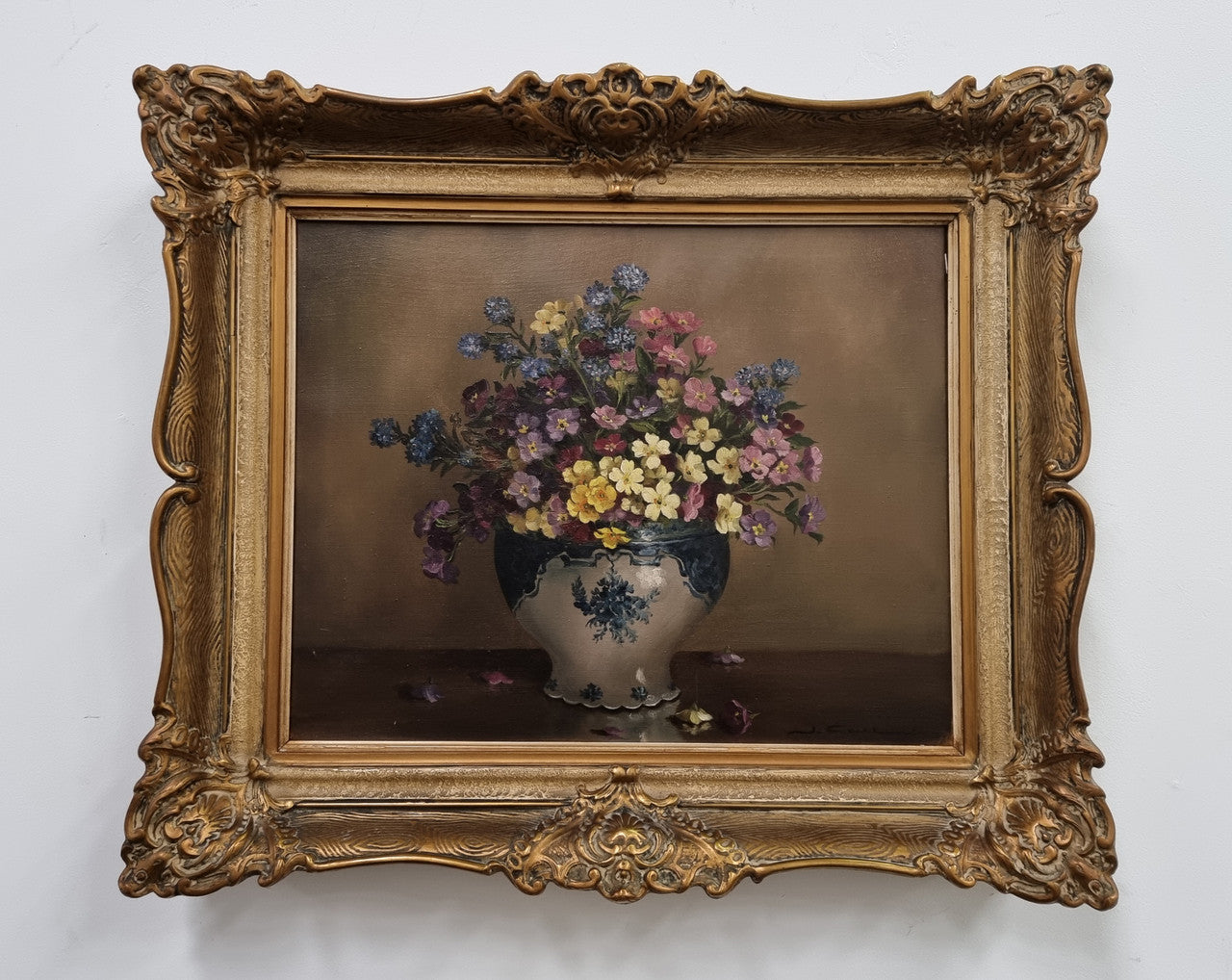 Attractive signed oil on canvas depicting flowers in a blue and white Jardinière in a stunning gilt frame. In good original detailed condition.