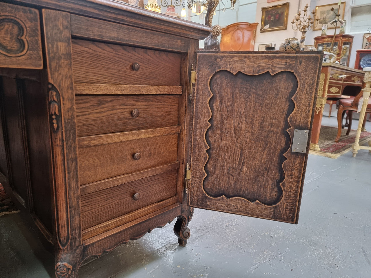 Fabulous Louis XV style French Oak beautifully carved full partners desk with an amazing tooled leather top. Both sides have a functioning drawer in the middle and two cupboards either side. On both sides one cupboard door opens up to four smaller internal drawers. Plenty of storage space and a large top surface to work on. It is in good original detailed condition.