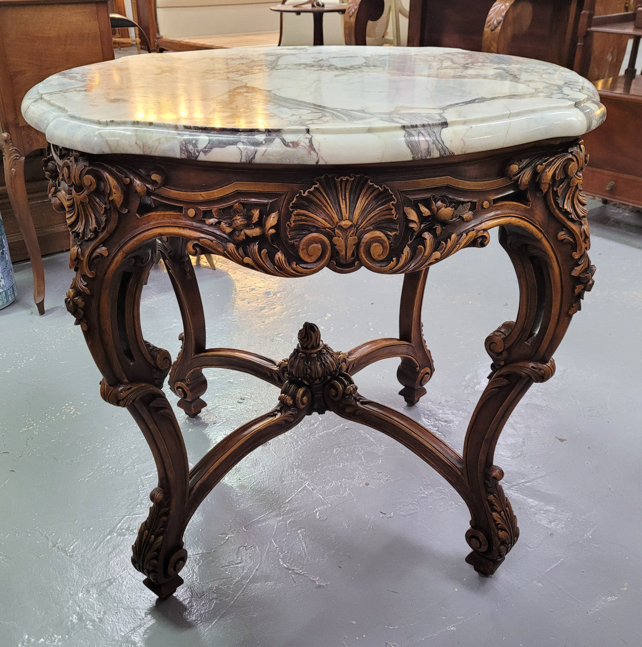 French Walnut Louis XV style round marble top centre table. It has amazing eye-catching marble, ornate detailed carvings and a beautifully carved undercarriage. In good original detailed condition.