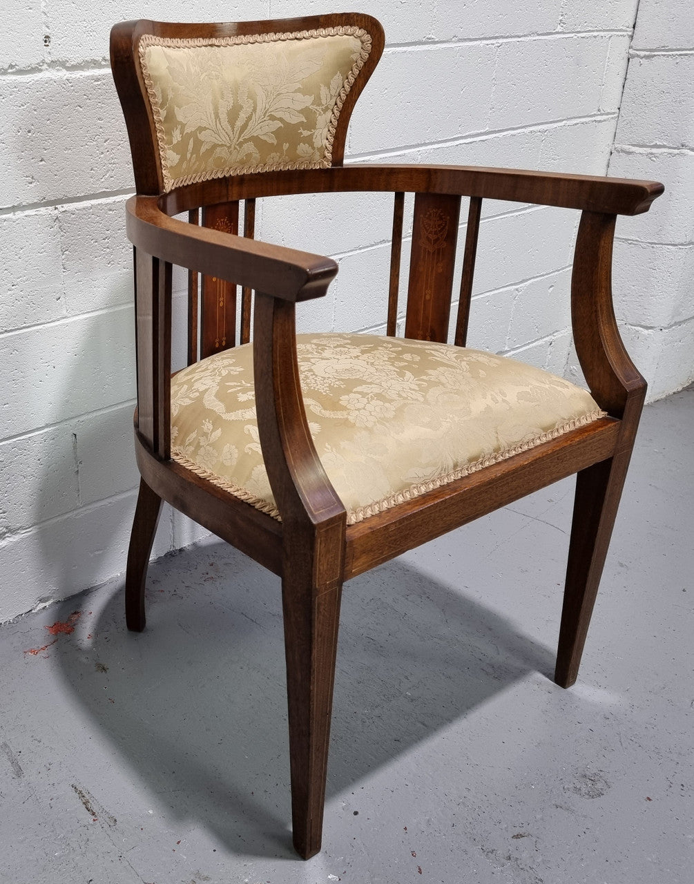 Charming Edwardian inlaid walnut upholstered armchair. In good original condition.
