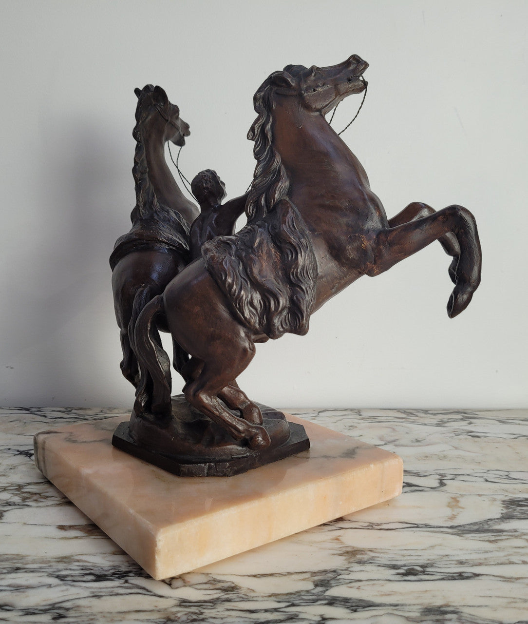 French Art Deco cold painted bronze metal marley horses style statue on a marble base. It is in good condition.