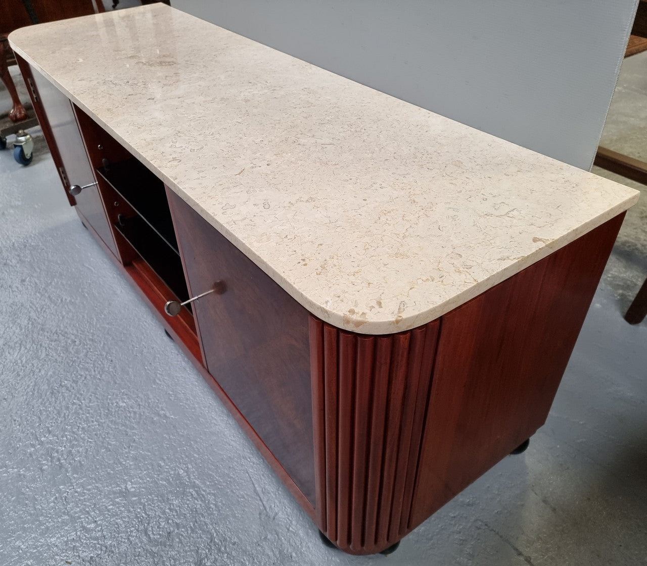 Beautiful Bespoke Art Deco style walnut and mahogany low line cabinet with a marble top and plenty of storage. It has two doors with a shelf each side and in the middle in has two glass shelves. Would make an ideal TV cabinet and has a hole in the back to run cords through. In very good original detailed condition.