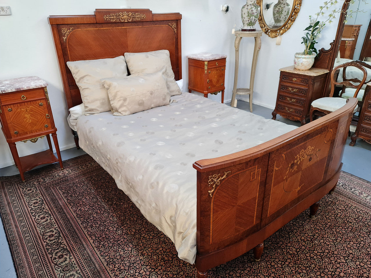 A high quality French Louis XV style bow fronted Queen size bed with marquetry inlay and ormolu mounts. In good original detailed condition. Circa: 1920