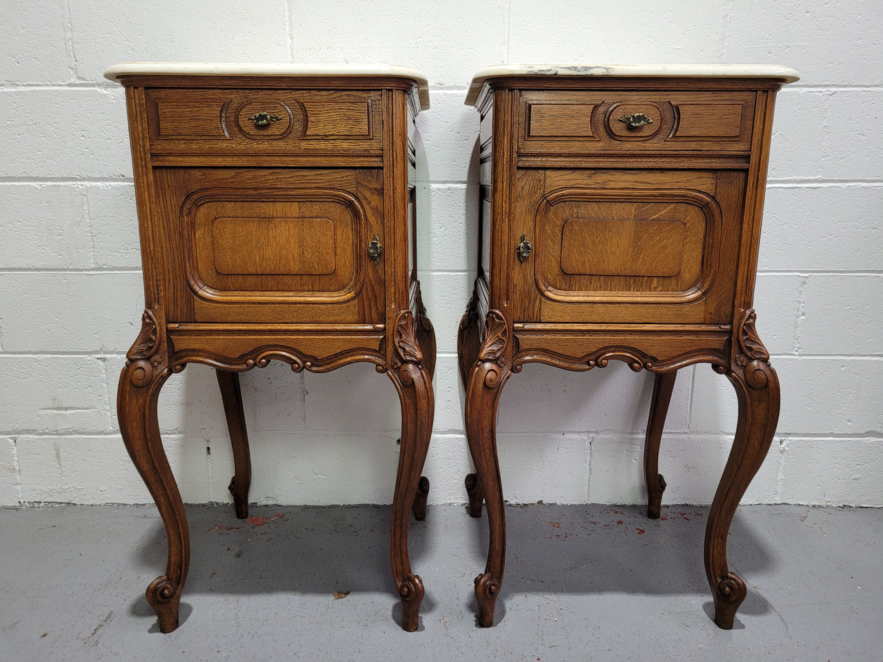 Pair of Louis XV style bedside cabinets with beautiful marble tops and one drawer and single cupboard for all your storage needs. In good original detailed condition.