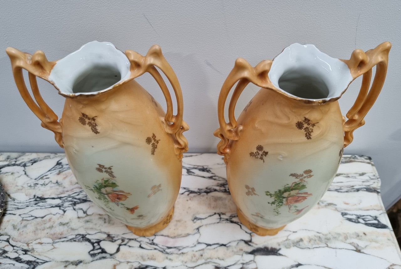 Decorative Pair of Art Nouveau Vases decorated with hand finished roses in muted tones. Gilt highlights. Impressed numbers to base. In good original condition, please view photos as they help form part of the description.