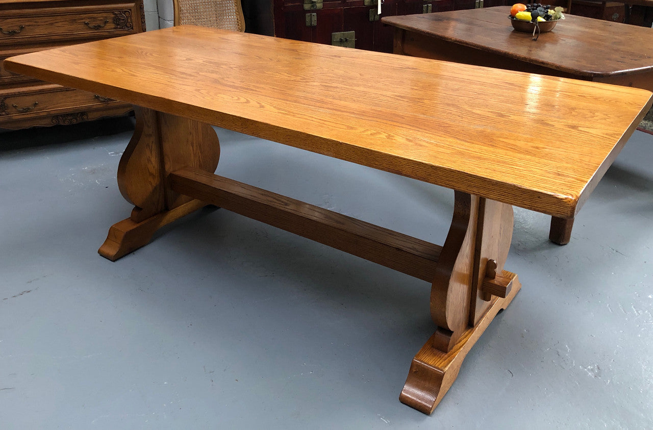 A French Style Oak stretcher base table with amazing wood grain. Can comfortable sit 6-8 people and is in original detailed condition.