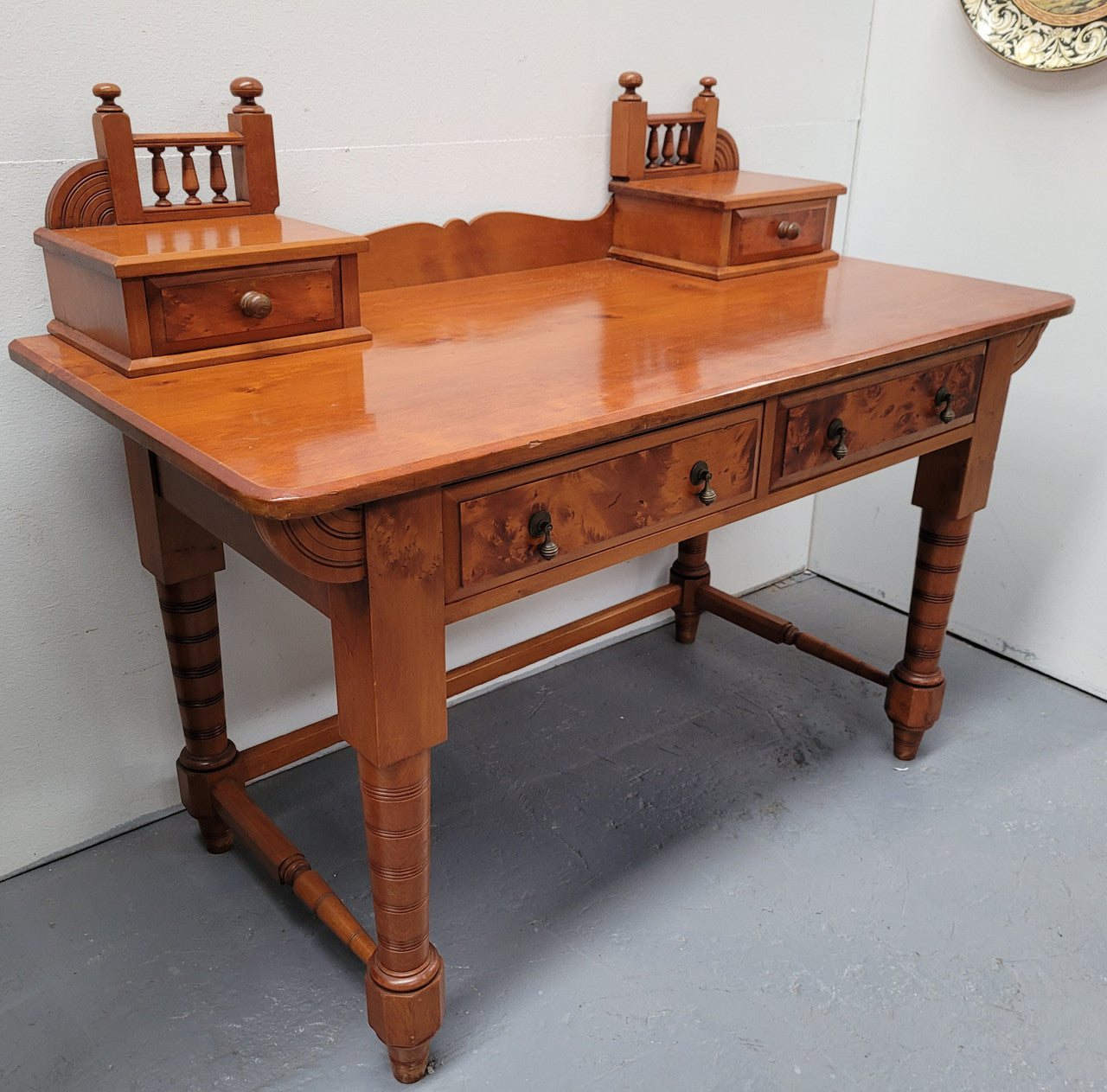 Late Victorian Huon Pine desk with two drawers. Featuring superb birdseye panels and is in good original detailed condition.