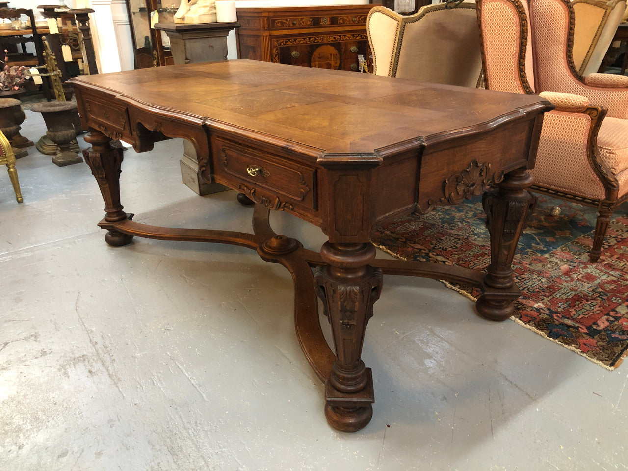 Beautifully carved 19th century French oak Bureau Plat. With a lovely parquetry top and two drawers and decorative carved legs this piece is definitely one to look at . In good original detailed condition.