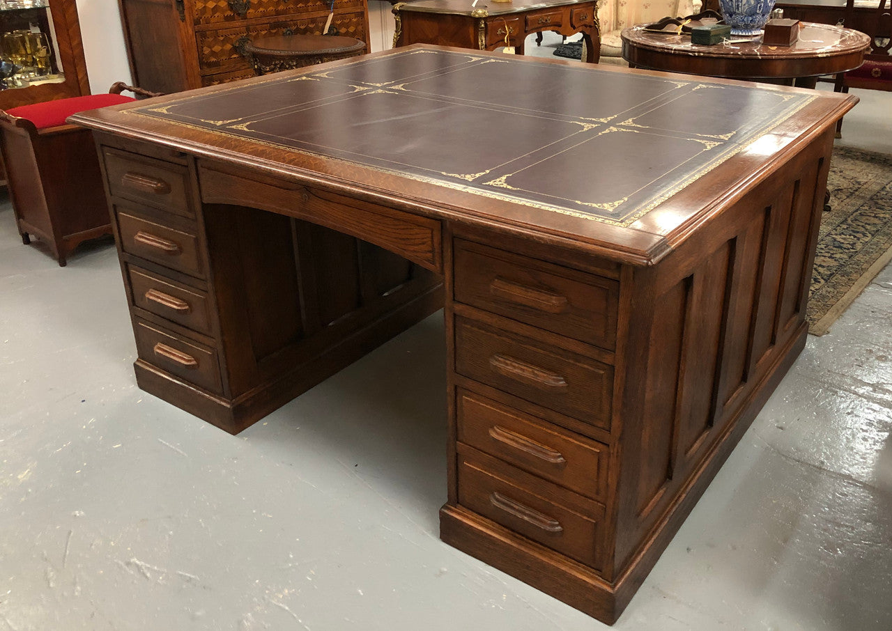 Lovely large English oak partners desk, with a beautiful burgundy tooled leather top. Plenty of storage space, both sides have 9 functioning drawers. It is in very good condition.