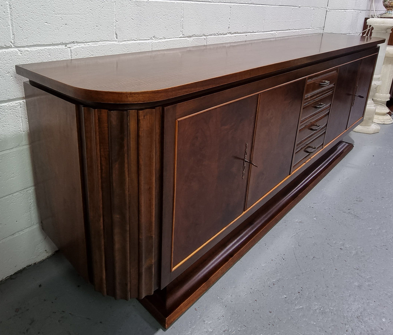 Amazing French Walnut Art deco four door buffet. The doors either side open to a fixed shelf and plenty of added storage with four drawers. In good original detailed condition.