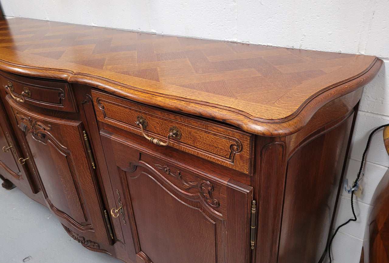 French Oak Louis XV style three drawer three door parquetry top sideboard. It has been sourced from France and is in good original detailed condition.