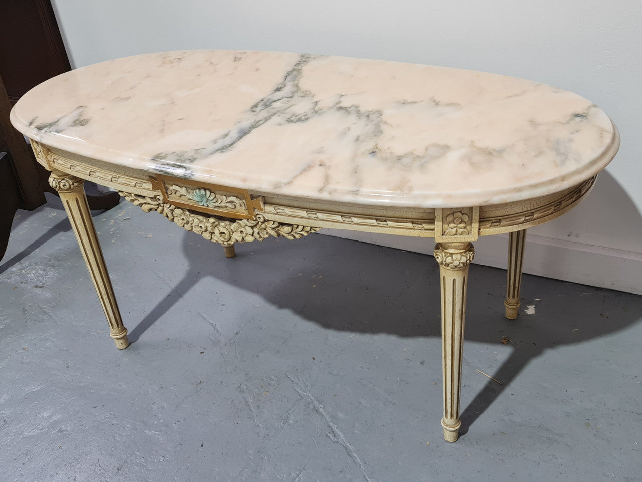 Charming painted Louis XVI style oval marble top coffee table. In good original detailed condition.