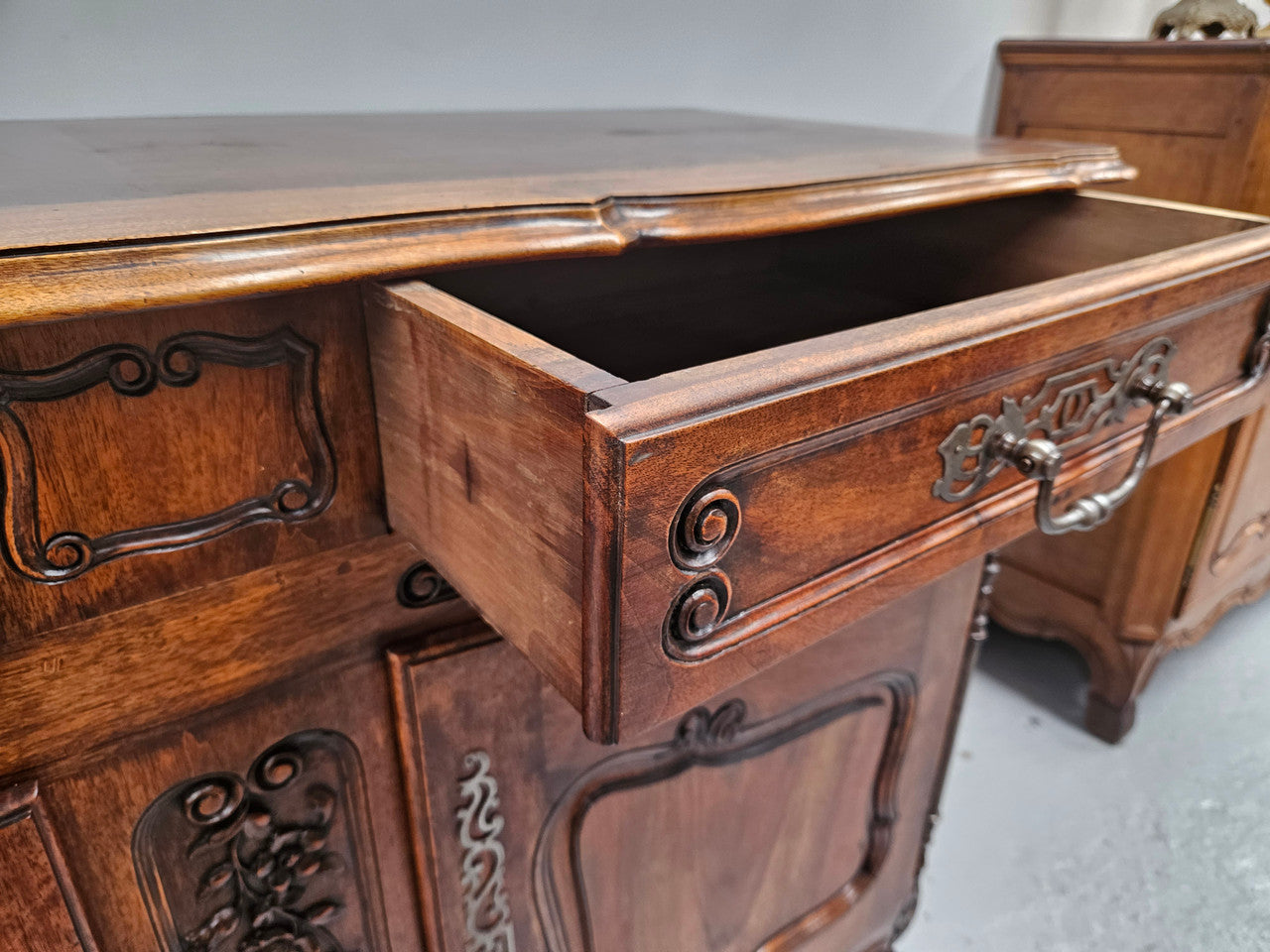 Attractive French Walnut Louis XV style two door two drawer sideboard featuring beautiful carving. Circa: 1930's. It has been sourced from France and it is in good original detailed condition.