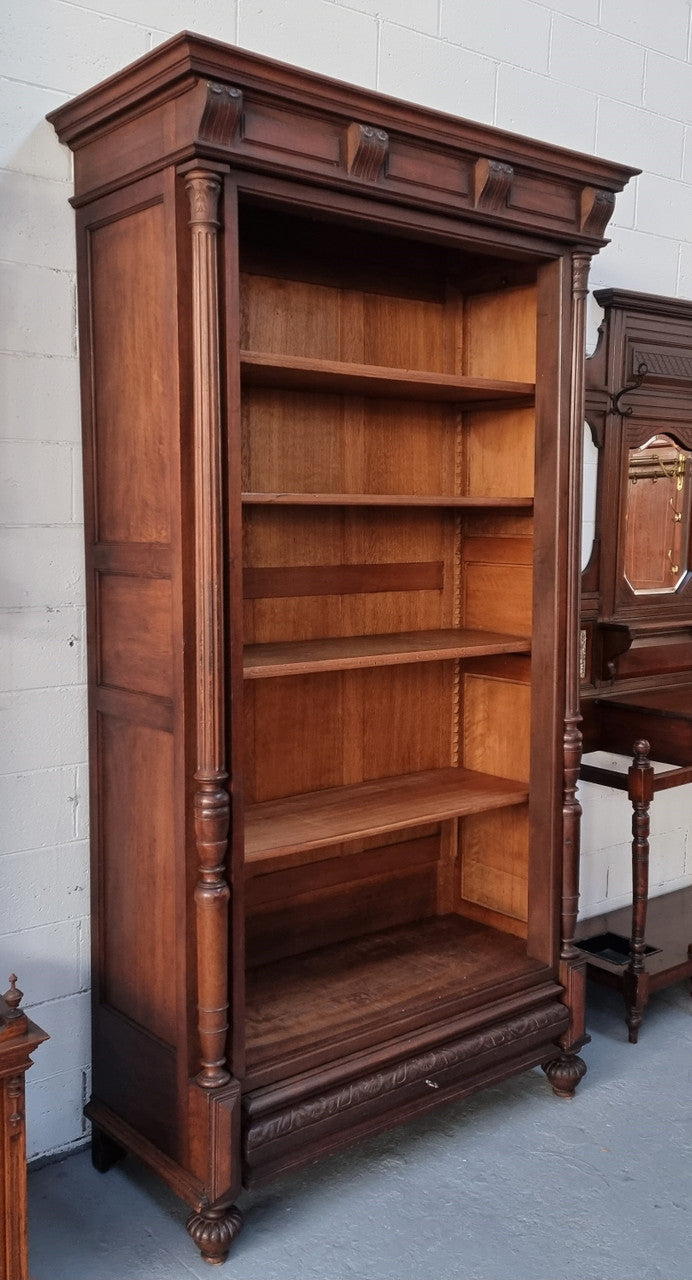 Henry II style 19th century walnut open bookcase with drawer which was originally an armoire now converted to a bookcase. It comes with four adjustable shelves. Is in good detailed condition.