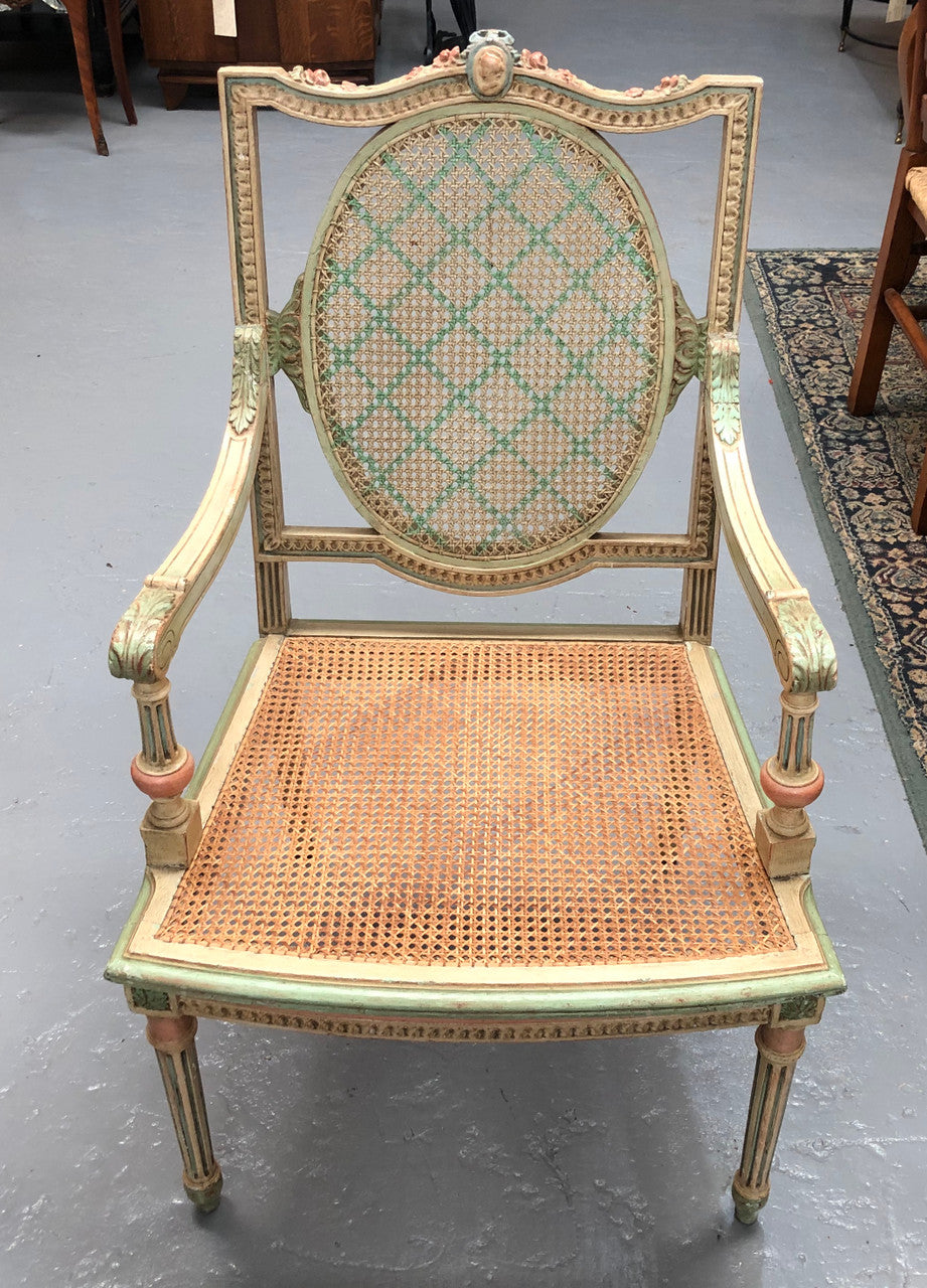 Painted French Louis XVI style cane panel arm chair. Paint is original and it is in very good original condition.