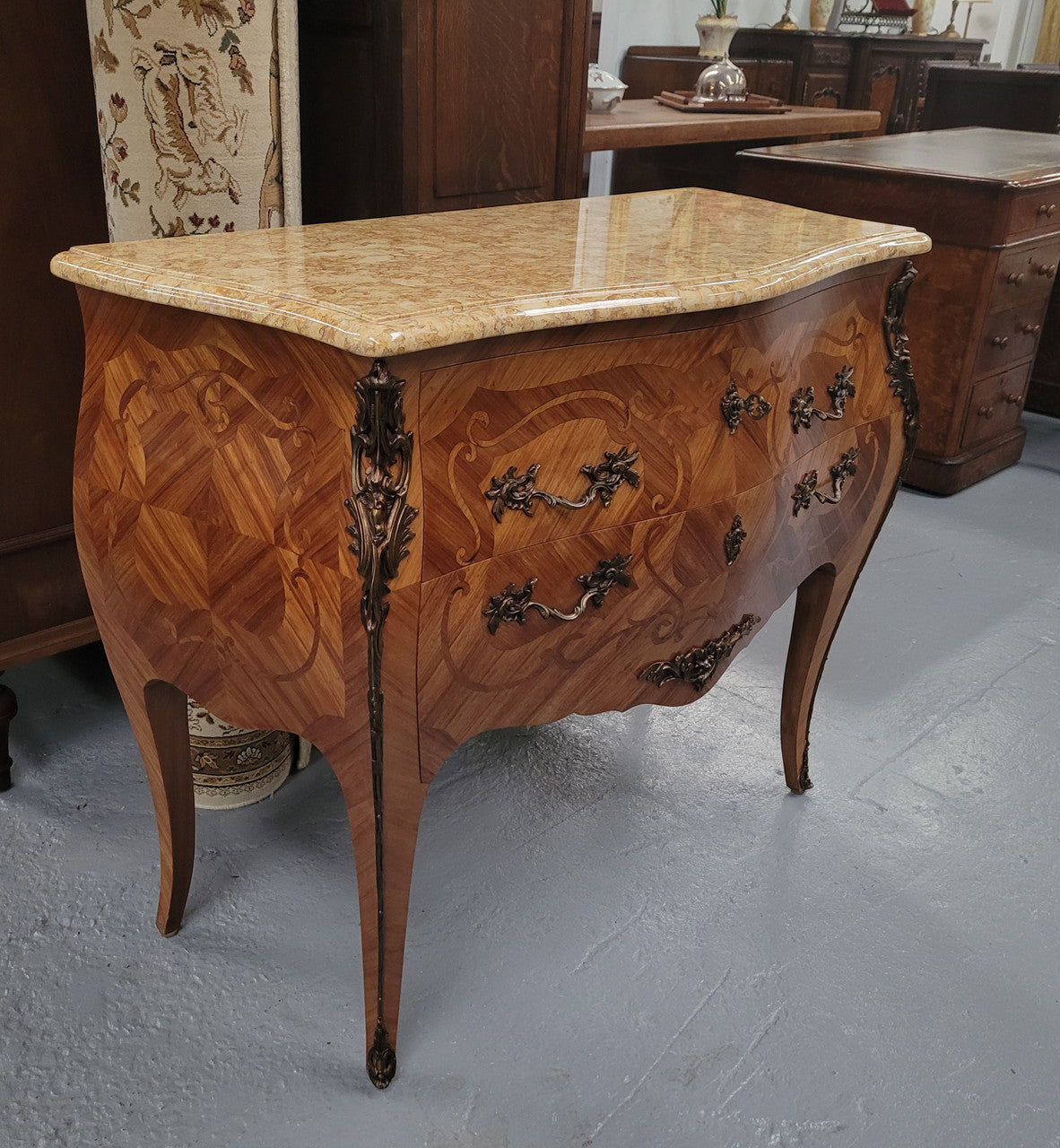 An elegant French Louis XV style kingwood two drawer commode with beautiful decorative inlay and ormolu mounts. Stunning coloured marble top and is in good original detailed condition.