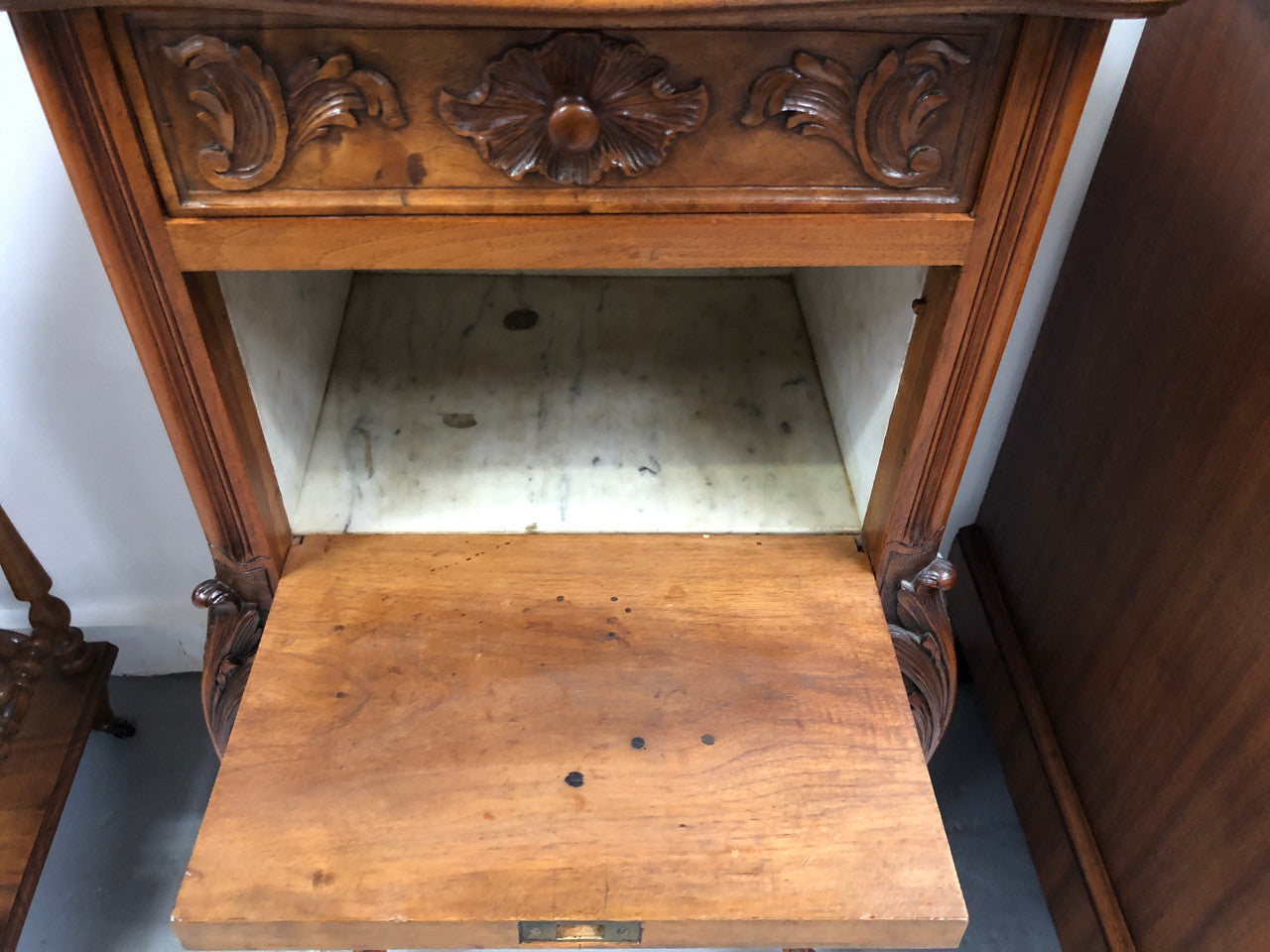 Single French carved bedside with inset marble top. It has beautiful carving and a drawer and cupboard for storage. In very good original detailed condition.