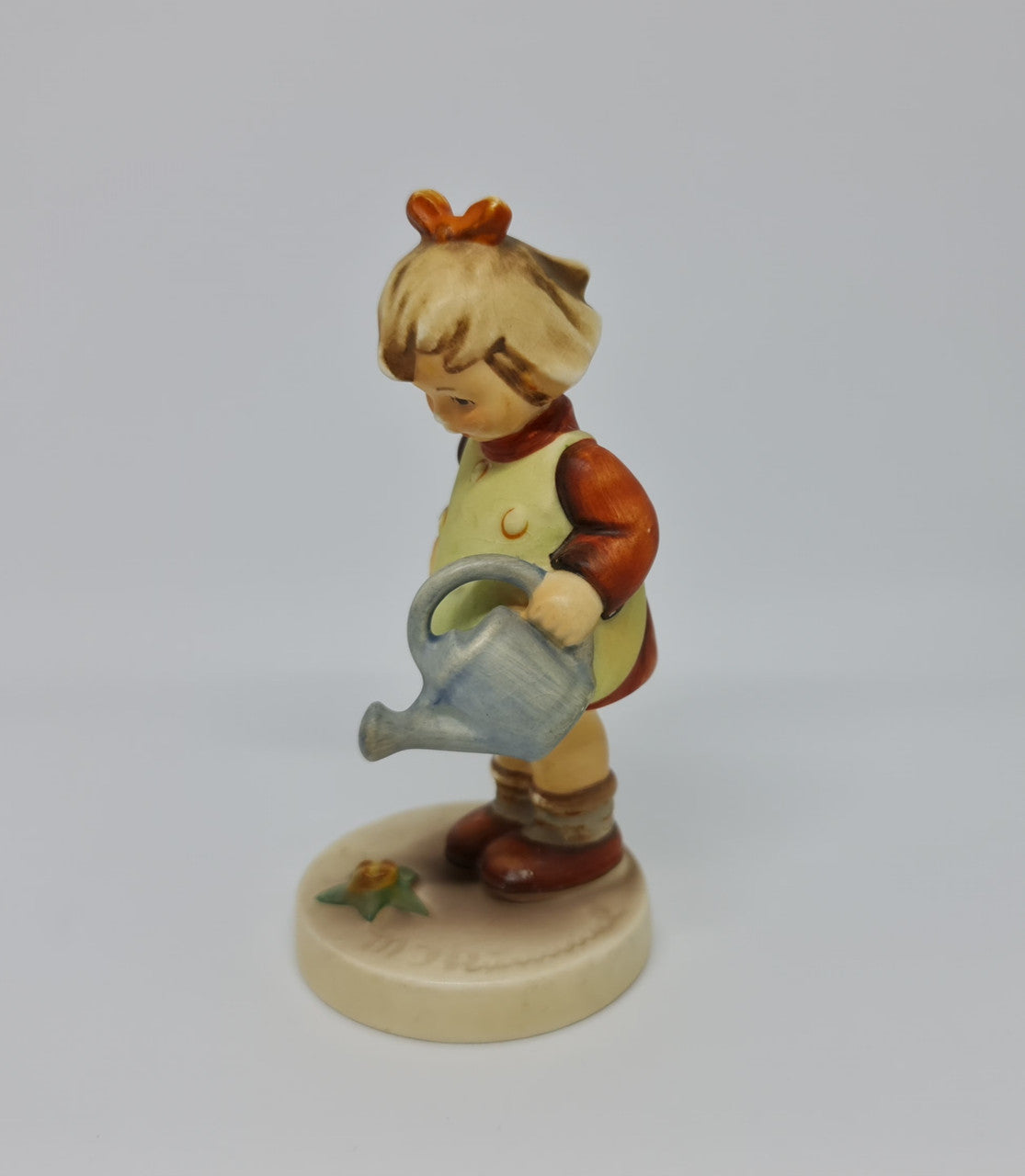 Gorgeous Hummel girl with watering can figurine, marked #74 . In great original condition.