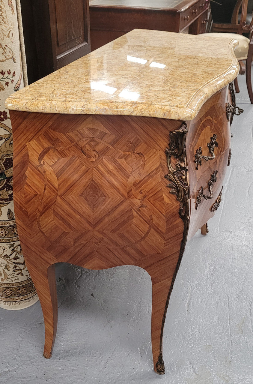 An elegant French Louis XV style kingwood two drawer commode with beautiful decorative inlay and ormolu mounts. Stunning coloured marble top and is in good original detailed condition.