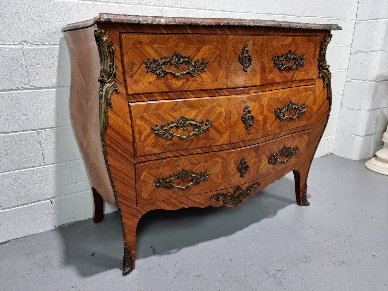 Attractive French marble top Louis XV style three drawer commode with decorative ormolu mounts. In good original detailed condition.