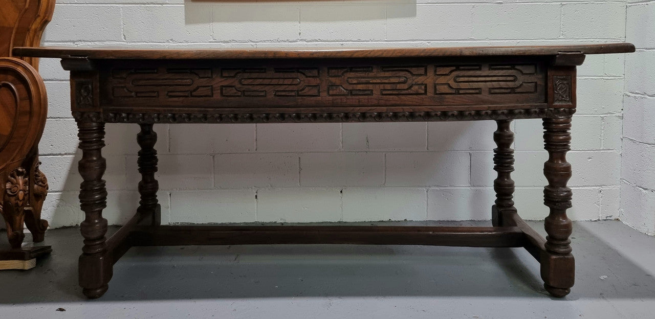 Rare and Charming 17th Century Spanish Walnut serving / side table. It has an incredible one piece walnut top with amazing character and colour. The base displays the original patina aswell as three drawers with carving and remnants of original locks. Superbly turned legs terminating on a stretcher base. Could be used as a large entrance console table, a side table or in a dining area as a serving table. In good original detailed condition especially considering its age.